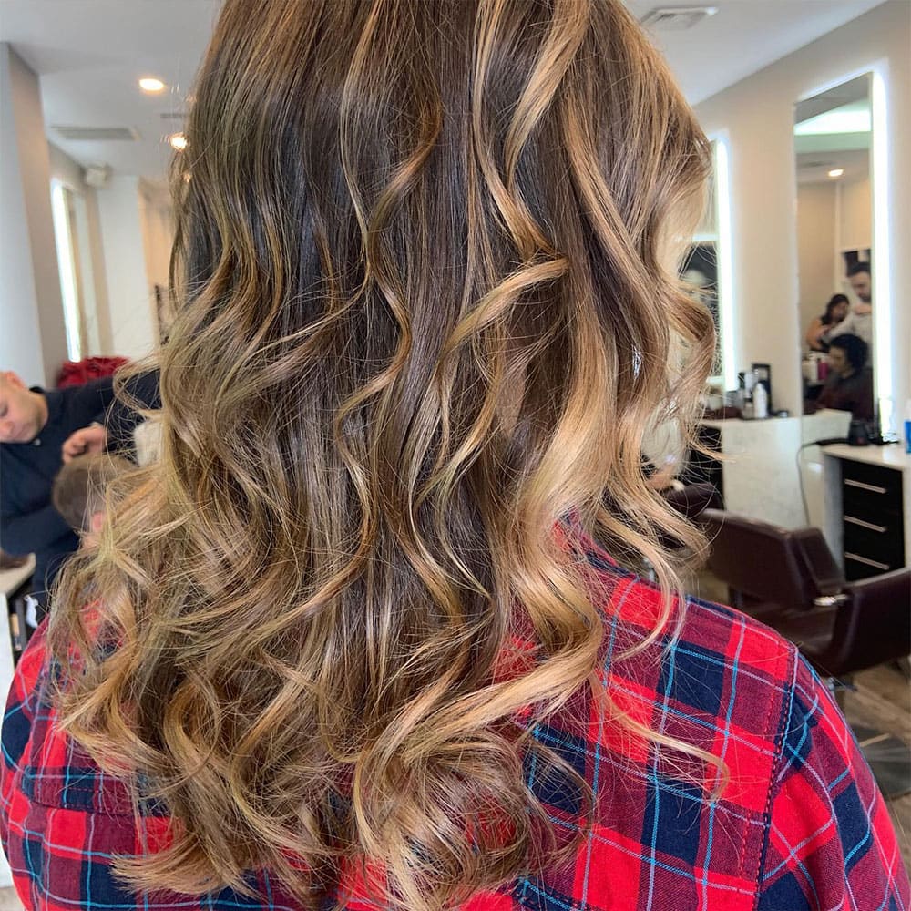 woman coming into numi hair salon in scarsdale for balayage from buchanan