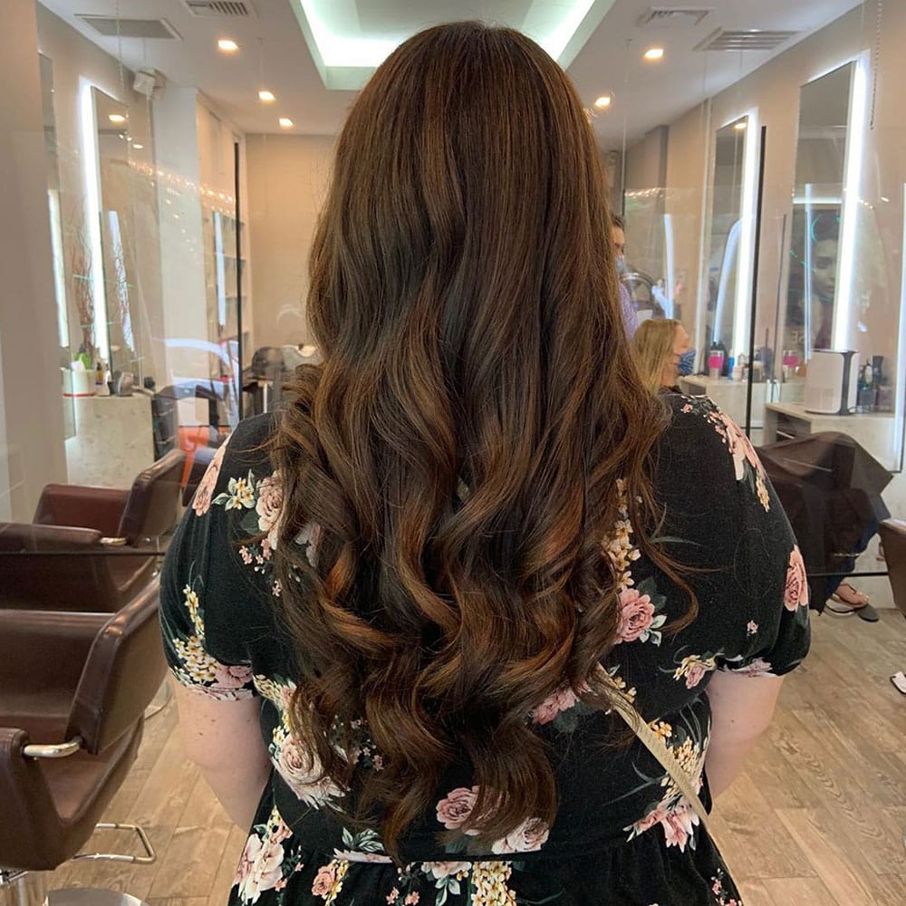 woman with brunette hair after blowout after commuting from croton on hudson to numi hair salon in scarsdale