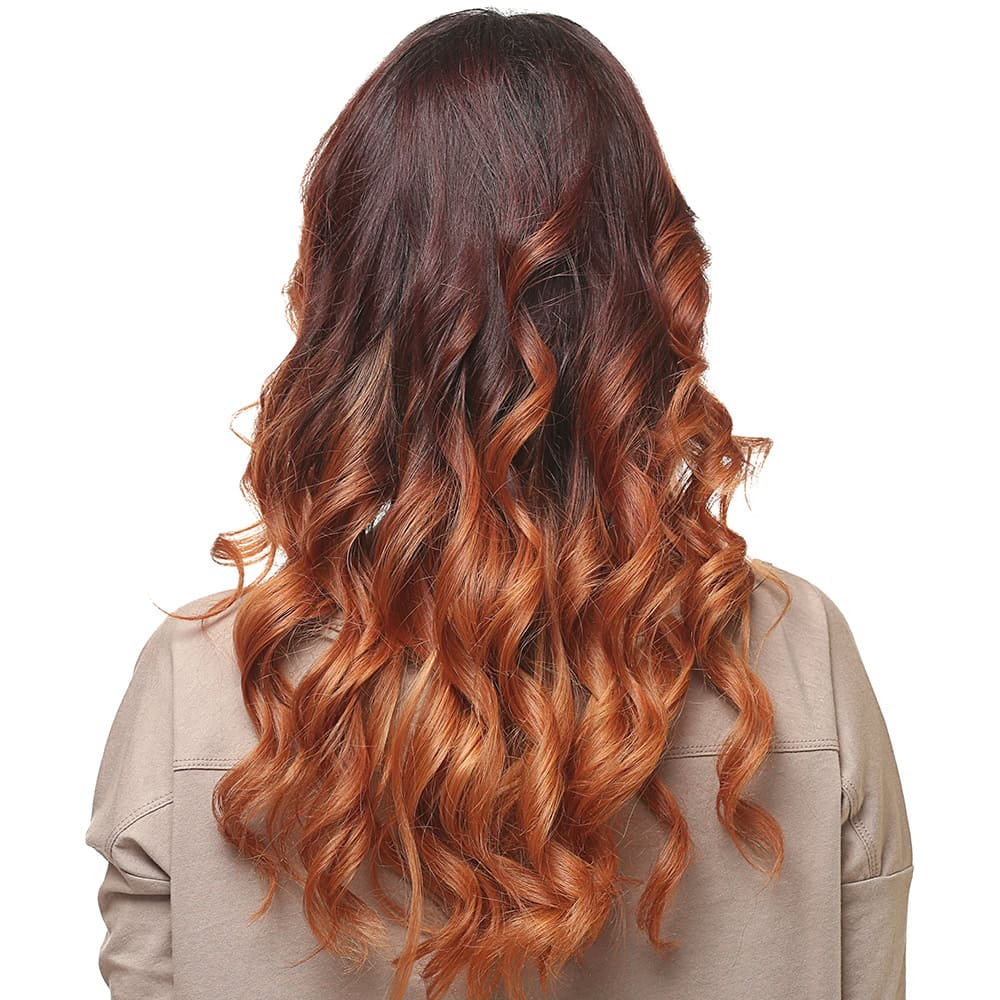 Seamless color melting gradient from brunette into honey blonde at Numi Hair Salon in Scarsdale, NY