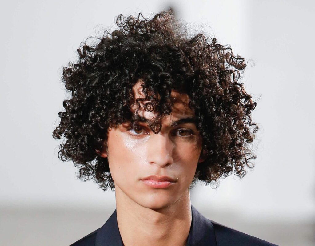 Long, loose, healthy curly haircut at Numi Hair Salon