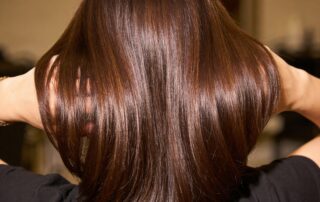 glossy brunette hair after salon glaze treatment showing mirror-like shine