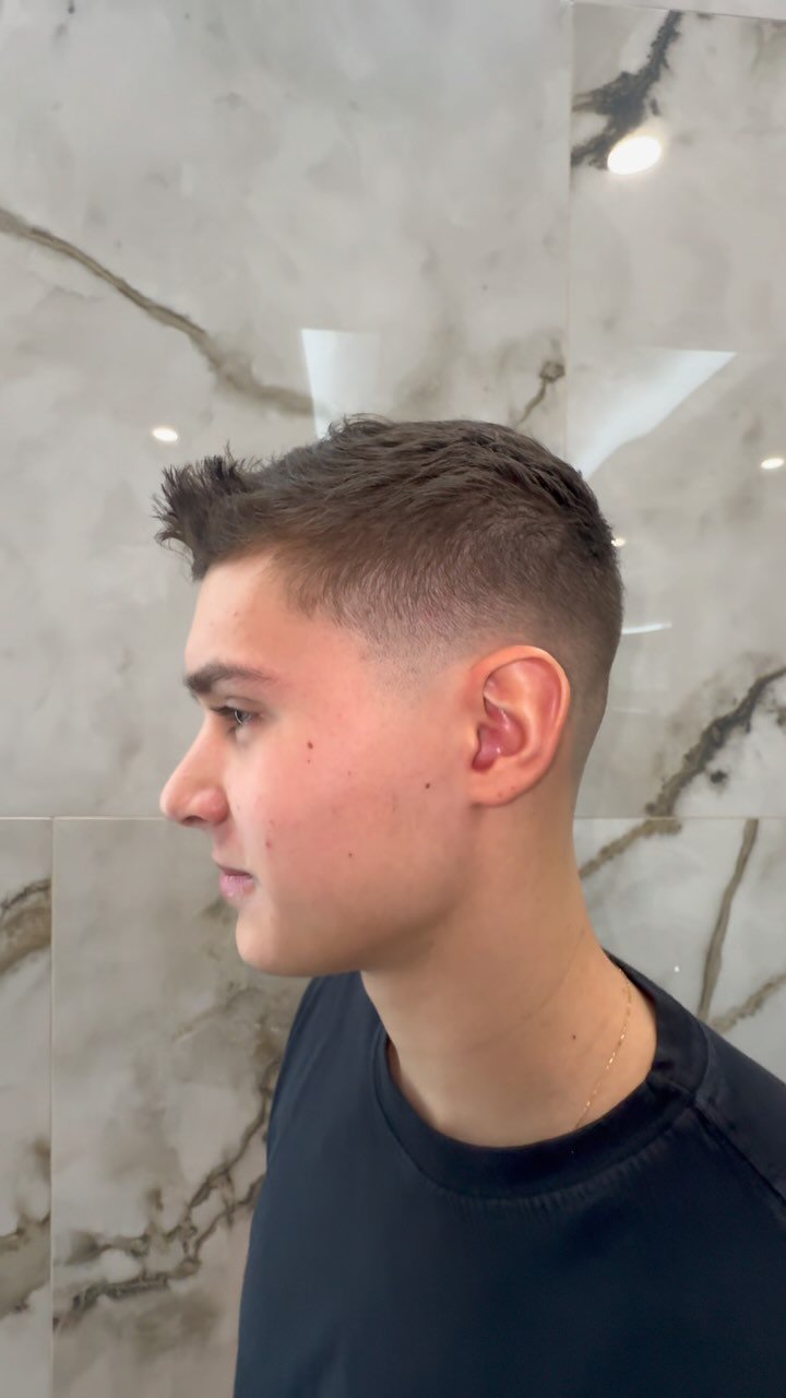 modern men's haircut with textured top at Numi Hair Salon