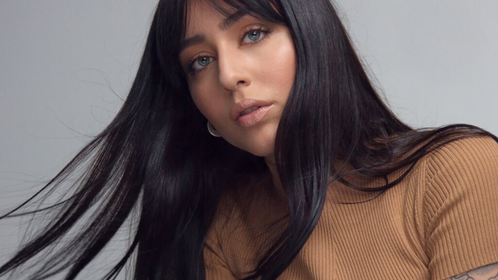 Glossy dark brunette hair after clear glaze treatment showing mirror-like shine