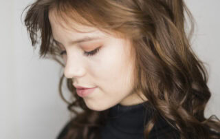 Layered shag haircut with curtain bangs adding volume to fine hair