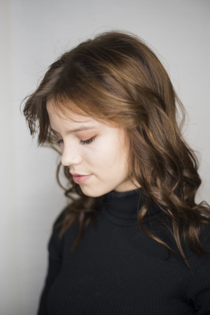 Layered shag haircut with curtain bangs adding volume to fine hair