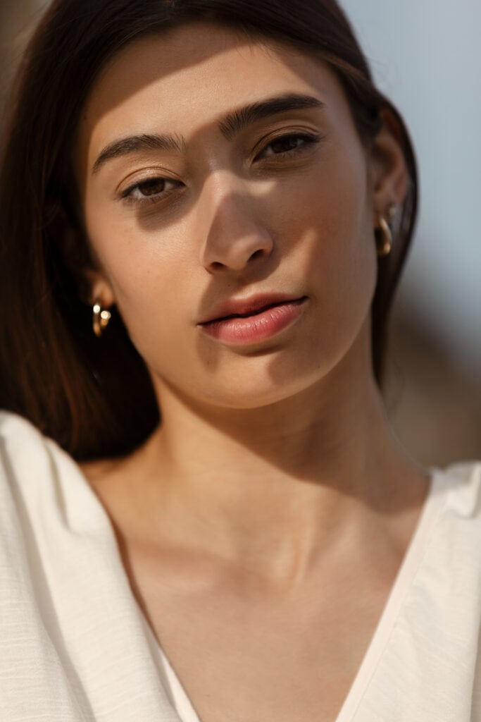 Woman with olive skin tone and dark hair showing greenish-yellow undertones