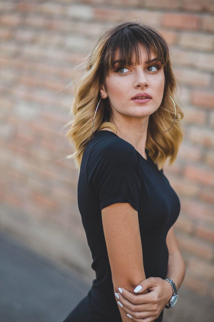 Collarbone cut with curtain bangs and face-framing highlights for fine hair