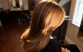 Partial highlights result at Numi Hair Salon in Scarsdale showing warm honey blonde highlights on brunette base with natural dimension