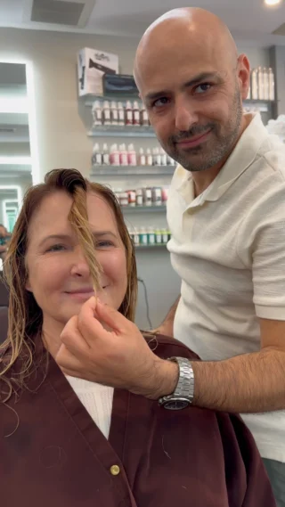 Stylist sectioning a client's hair at the salon